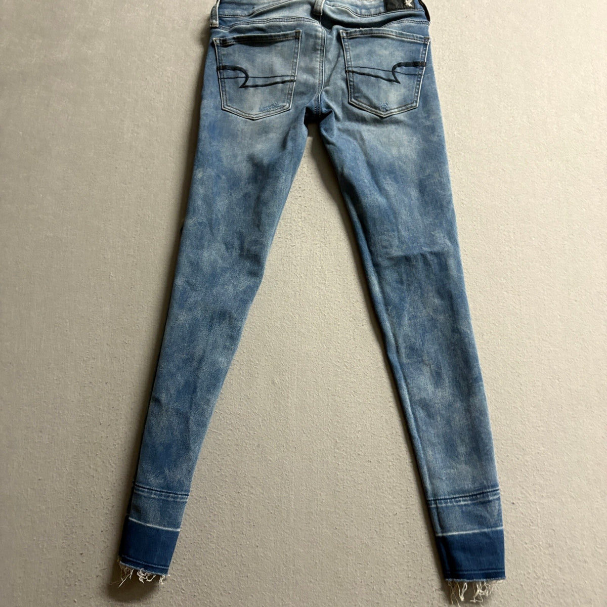 American Eagle Super Low Jegging Jeans Womens 4 Blue Distressed Raw Hem Stretch